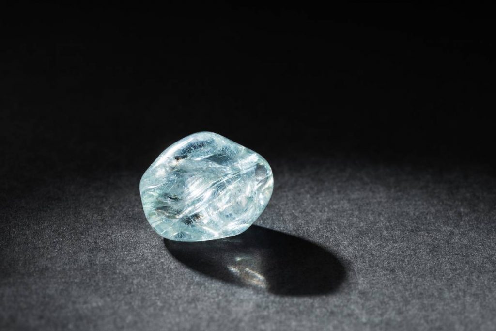 Tumbled Pale Blue Aquamarine Gemstone on Black Background. Healing Breath Stone is Believed to Cure Respiratory Problems