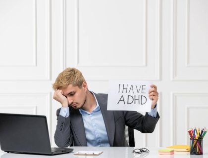 ADHD cute young stressed worker in the office behind desk with computer very tired and sleepy